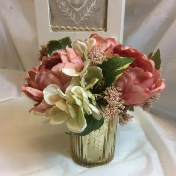 A flower arrangement of large peonies & hydrangea
