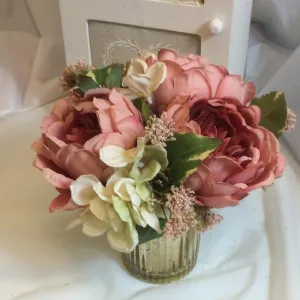 A flower arrangement of large peonies & hydrangea